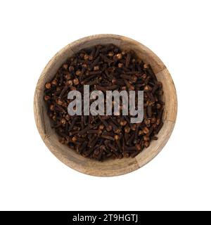 whole carnation in wooden bowl isolated on white background, dry spice cloves Stock Photo