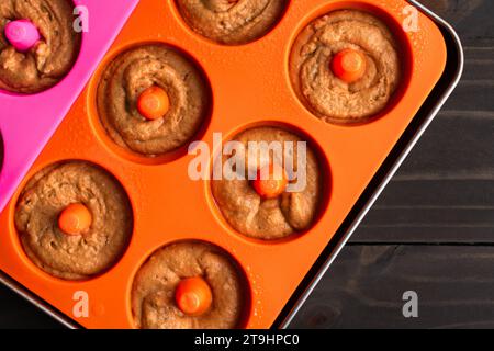Baked Apple Cider Donut Batter in Silicone Donut Molds: Pastry batter that has been piped into silicone doughnut molds ona sheet pan Stock Photo