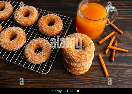 Baked Apple Cider Donuts with Cinnamon Sugar Coating: Baked doughnuts cooling on a wire rack viewed from directly above Stock Photo