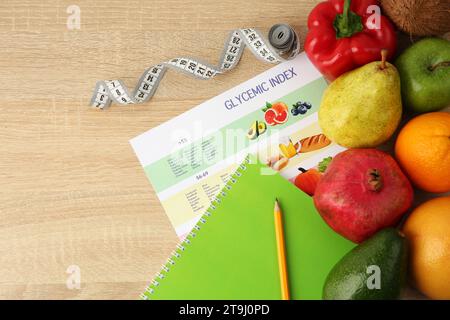 Flat lay composition with products and Glycemic index chart on wooden table, space for text Stock Photo