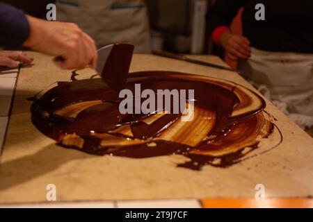 Chocolatier spreading chocolate as a demonstration Stock Photo