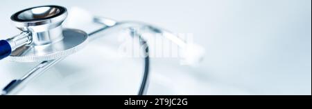 Close-up of a stethoscope on a light blue table. Stock Photo