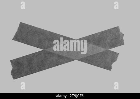 Black tape on gray background. Torn black sticky tape, adhesive pieces. Stock Photo