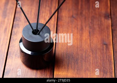 Aromatic Black Essential Oil Diffuser with Sticks on Wooden Boards Stock Photo