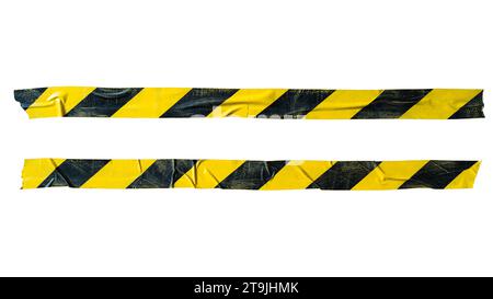 Distressed yellow and black barricade tape on white background with clipping path Stock Photo