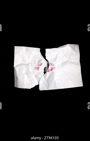 Torn White Envelope with Red Lipstick Kiss on Black Stock Photo