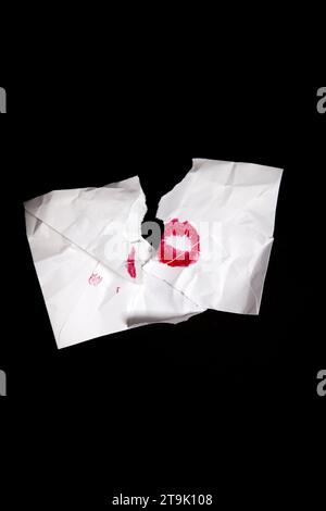 Torn White Envelope with Red Lipstick Kiss on Black Stock Photo