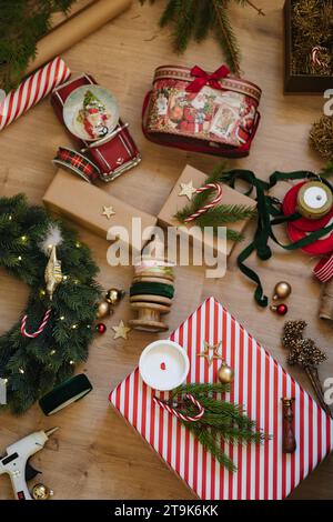 Element of Christmas decor on floor. Top view of Christmas present wreath fir tree branch and snow globe Stock Photo