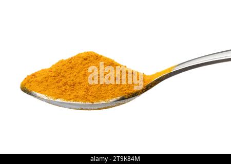 Metal spoon with Turmeric, Curcuma longa ground  powder on white backgroundclose up Stock Photo