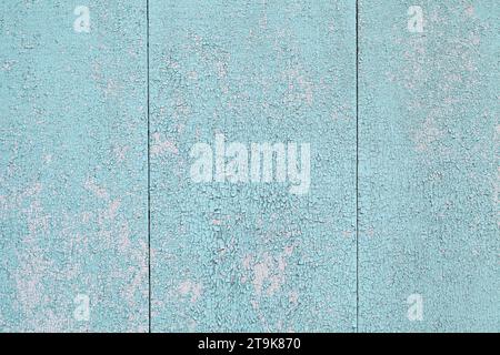 Background with peeling old blue paint, wooden planks vertical. Stock Photo