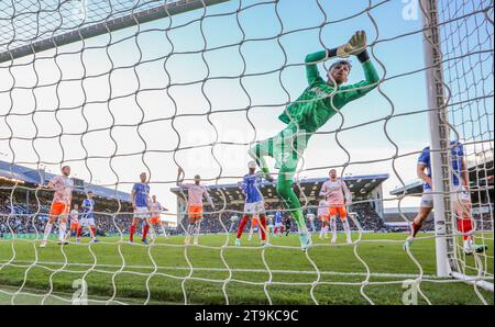 Portsmouth, UK. 25th Nov, 2023. Blackpool goalkeeper Daniel Grimshaw (32) saves during the Portsmouth FC v Blackpool FC sky bet EFL League One match at Fratton Park, Portsmouth, England, United Kingdom on 25 November 2023 Credit: Every Second Media/Alamy Live News Stock Photo