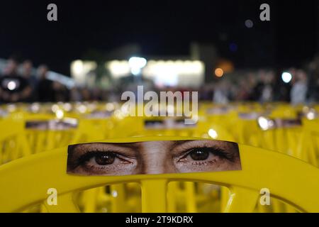 Images of people's eyes adorn empty yellow chairs, representing Israelis hostages held by Hamas in Gaza, placed in the plaza now called 'The Hostages and Missing Square' outside The Museum of Modern Art during a rally attended by tens of thousands of people in support of the 212 hostages that are still being held by Hamas, as another 13 Israeli hostages were released from Gaza, during the second day of the ceasefire on November 25, 2023 in Tel Aviv, Israel. A total of 50 hostages currently held by Hamas are to be released during a four-day truce with Israel, Stock Photo