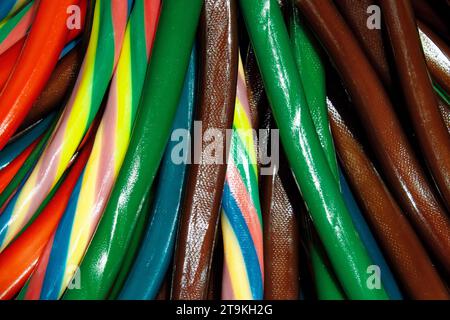 a top-down view of colorful candy sticks in red, green, blue, yellow, and orange, arranged in a pattern. Stock Photo