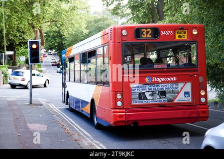 back of number 32 local red bus at traffic lights in Torquay Devon U.K Stock Photo