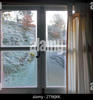 Frozen window frame condensation inside, close up. Ice builtup on