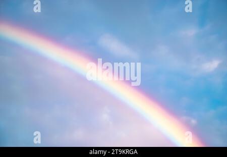 Beautiful rainbow in sky exposing full range of colors as diversity and art Stock Photo