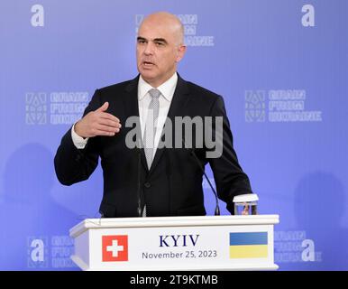 President of the Swiss Confederation Alain Berset holds a copy of the ...