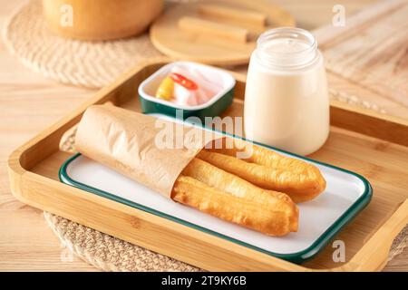 Youtiao (Chinese fried breadstick). Long golden brown deep fried dough strip.dough stick and soy milk Stock Photo