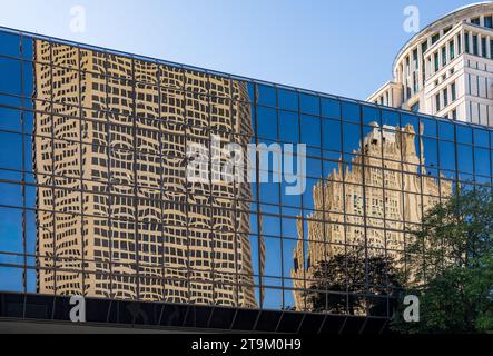 Reflections of two modern office skyscrapers in a mirrored building on Market street in downtown St Louis in Missouri Stock Photo