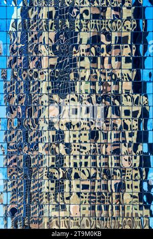 Reflections of a modern office skyscraper in a mirrored building in downtown St Louis in Missouri with each window reflecting a different section Stock Photo