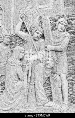Bas-relief of Jesus restrained, captured and guided by the guard. Stock Photo