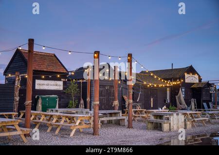 Evening light at the fishmonger stalls and fish restaurant huts along Blackshore, Southwold harbour. Stock Photo