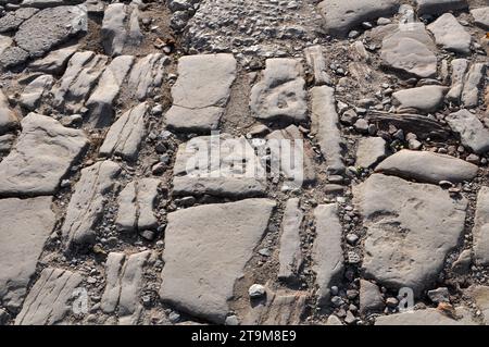 Old stone cobblestones from which the road is paved Stock Photo