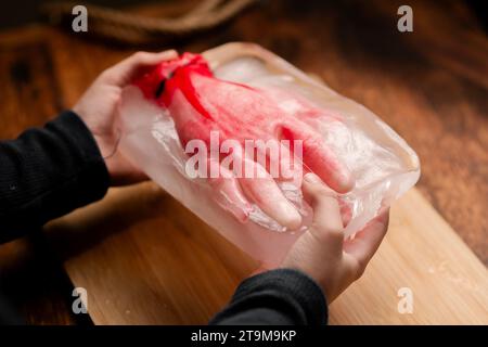 Halloween Horror: A child showcasing a frozen mannequin hand in icy grasp, evoking a Halloween-themed fright and suspenseful atmosphere, ideal for chi Stock Photo