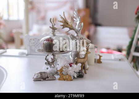Christmas Decorations of a Table in white and gray colors with reindeer Stock Photo