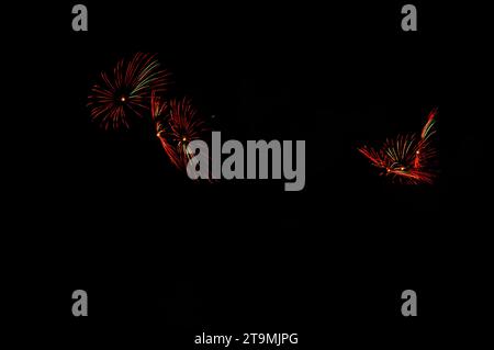 Colorful celebration fireworks isolated on a black sky background. Stock Photo