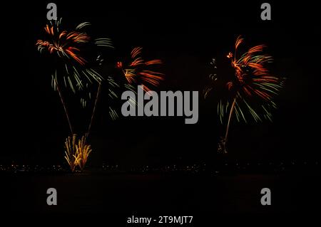 Colorful celebration fireworks isolated on a black sky background. Stock Photo