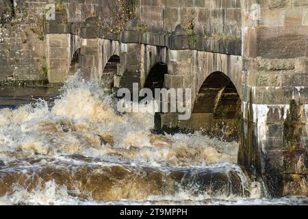 Stone sluice gate arches on the River Derwent at Belper East Mill, Belper, Derbyshire, England Stock Photo