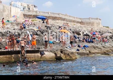 Blue Grotto, Malta - August 22, 2019: Coastal view of the Blue Grotto beach full of people on a sunny day Stock Photo