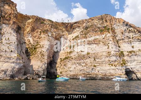 Blue Grotto, Malta - August 22, 2019: Coastal landscape with rocks and pleasure motor boats on a  sunny summer day Stock Photo