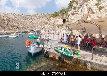 Blue Grotto, Malta - August 22, 2019: Tourists wait for a Blue Grotto boat trip departure on a sunny day Stock Photo