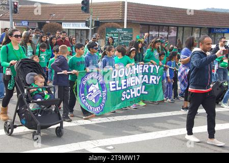 Dublin, CA - March 18, 2023: Participants in the 39th Saint Patrick’s Day Parade.  Students from Dougherty Elementary School walking down the street. Stock Photo