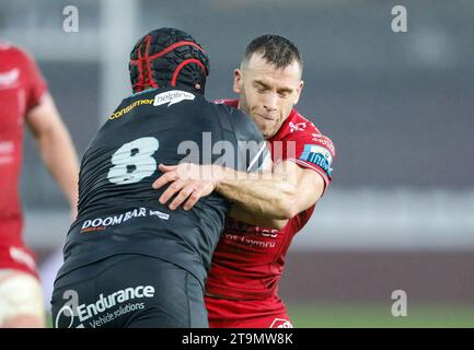 Swansea, UK. 26th Nov, 2023. Morgan Morris of the Ospreys (l) is tackled by Gareth Davies of the Scarlets .United Rugby Championship, Ospreys v Scarlets at the Swansea.com stadium in Swansea, South Wales on Sunday 26th November 2023. pic by Geraint Nicholas/Andrew Orchard sports photography/Alamy Live news Credit: Andrew Orchard sports photography/Alamy Live News Stock Photo