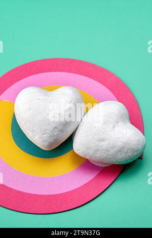A couple of pure white hearts on a rainbow of love. Stock Photo