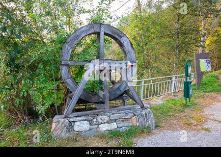 Paddle wheel of a watermill showing direction to the mill road Stock Photo