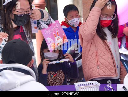 San Francisco, CA - April 15, 2023:Participants enjoying the CYC Spring Festival at Waverly Place in Chinatown. Kids participating at booth events. Stock Photo