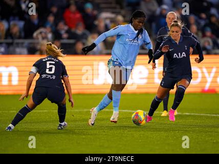 Manchester City's Khadija Shaw (centre) battles for the ball with Tottenham Hotspur's Molly Bartrip (left) and Shelina Zadorsky during the Barclays Women's Super League match at Manchester City Joie Stadium, Manchester. Picture date: Sunday November 26, 2023. Stock Photo