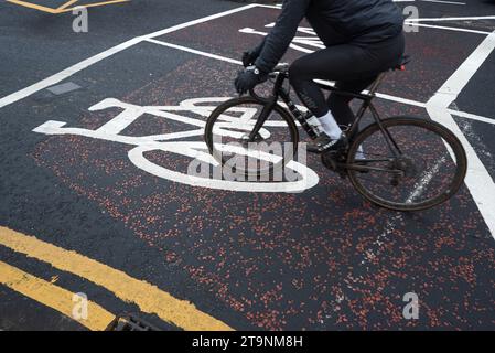 Cyclist cycling over a cycle road marking. Stock Photo