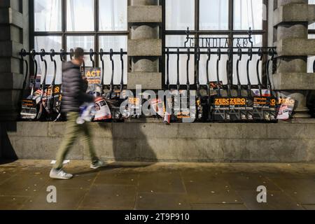 London, UK. 26th November, 2023. A man walks past discarded placards and signs as the March Against Antisemitism ends in central London. Tens of thousands joined the demonstration, marching from the Royal Courts of Justice, through to Parliament Square. The rally is said to be the largest of its kind since the Battle of Cable Street in 1936. Credit: Eleventh Hour Photography/Alamy Live News Stock Photo