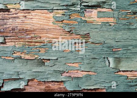 old weathered flaky cracked peeling green paint on old wood board background detail Stock Photo