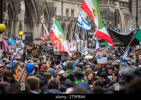 London, UK. 26th Nov, 2023. Protesters hold placards and wave Iranian and Israeli flags outside the Royal Court of Justice in London before the demonstration. Tens of thousands of people marched through central London from the Royal Court of Justice to the Parliament Square at the demonstration against antisemitism. According to the European Union the antisemitism is increasing fast since the Israel-Hamas war started on the 7th of October. (Photo by Krisztian Elek/SOPA Images/Sipa USA) Credit: Sipa USA/Alamy Live News Stock Photo