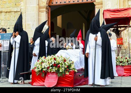 Penitents wearing Capirote hats during the Easter time Good Friday silent parade commemorating the Crucifixion and death of Jesus Christ, in Oaxaca city, Mexico Stock Photo