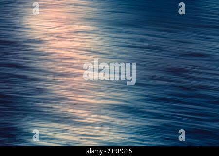 Abstract seascape. Beautiful pink sunset over the Pacific ocean, motion blur, soft light Stock Photo