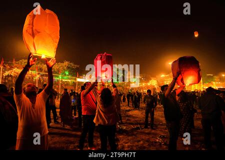 Varanasi, India. 26th Nov, 2023. A group of young people light a Sky Lantern during the Dev Deepavali Festival at Varanasi. Dev Deepavali/Diwali is the biggest festival of light celebration in Kartik Poornima (Mid-Autumn) where devotees decorate the river bank with millions of lamps during the festival. Credit: SOPA Images Limited/Alamy Live News Stock Photo