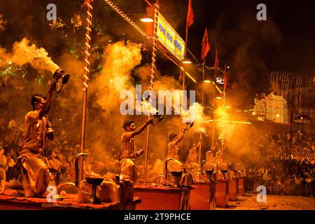 Varanasi, India. 26th Nov, 2023. Hindu priests perform 'Evening Aarati' prayers at Assi Ghat during the Ganga Aarti, a traditional and old Hindu ritual honoring the Ganges River. Dev Deepavali/Diwali is the biggest festival of light celebration in Kartik Poornima (Mid-Autumn) where devotees decorate the river bank with millions of lamps during the festival. Credit: SOPA Images Limited/Alamy Live News Stock Photo