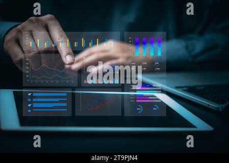 financial charts and graph analysis marketing floating above digital screen tablet, business KPI Dashboard strategy for growth and success on virtual Stock Photo